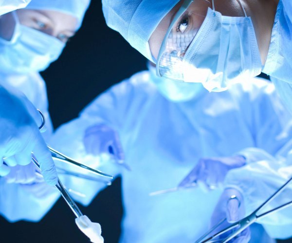 Team surgeon at work on operating in hospital .